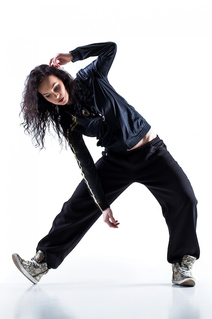 Modern dancer poses in front of the gray studio background. Modern dance  styles, dancehall, jazz funk, hip hop Stock Photo - Alamy