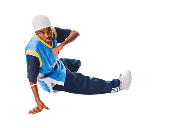 Hip-hop young man making cool move on white background