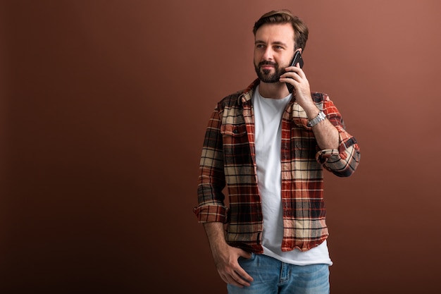 Uomo barbuto alla moda bello hipster su colore marrone