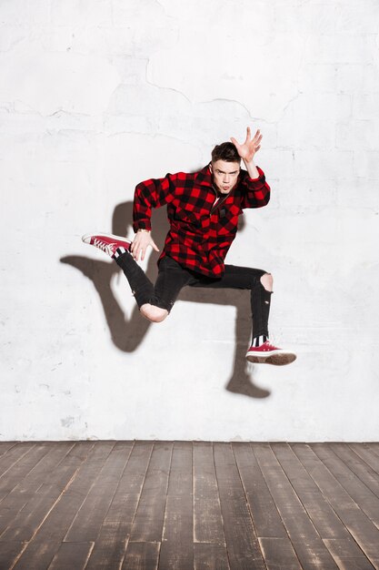 Hipster jumping in studio