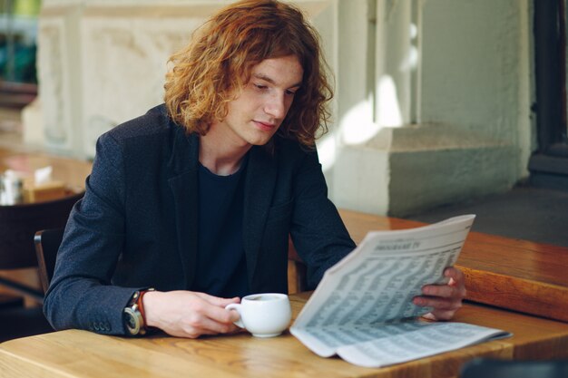 Hipster man drinking coffee while reading