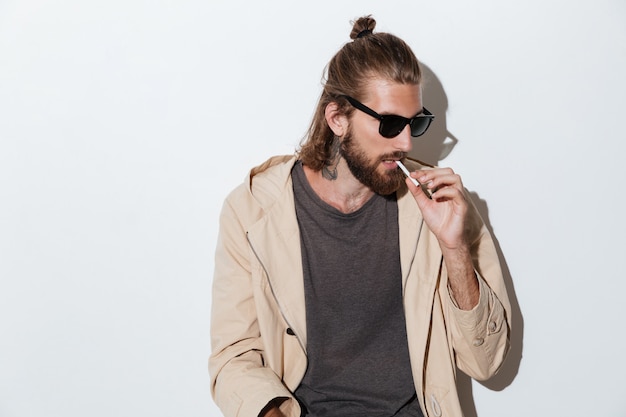 Hipster man looking aside isolated over wall