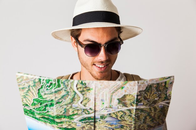 Hipster man looking at city map