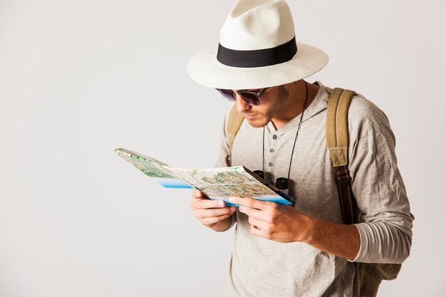 Hipster man looking at map