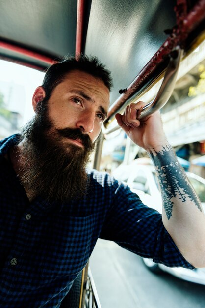 Hipster man riding a public transport