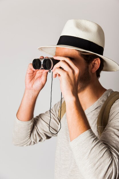 Hipster man using binoculars