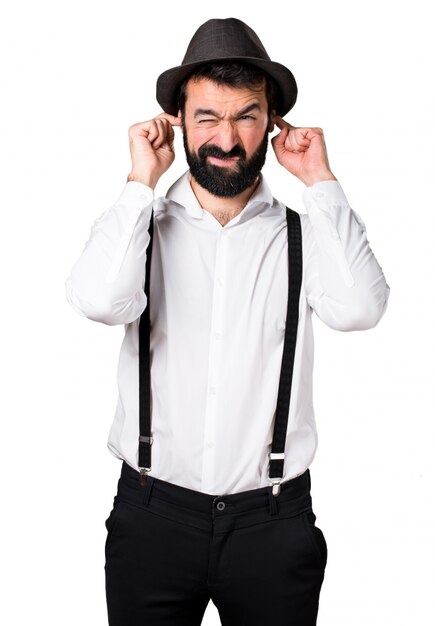 Hipster man with beard covering his ears