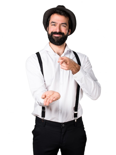 Hipster man with beard holding something