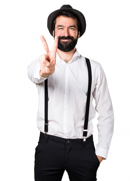 Hipster man with beard making victory gesture
