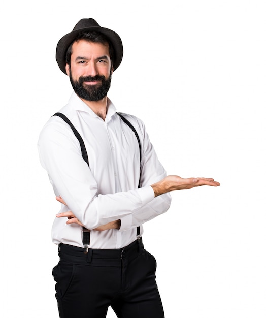 Free photo hipster man with beard presenting something