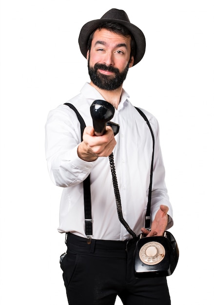 Free photo hipster man with beard talking to vintage phone