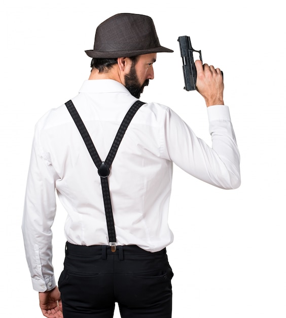 Бесплатное фото Человек-хипстер с бородой с пистолетом