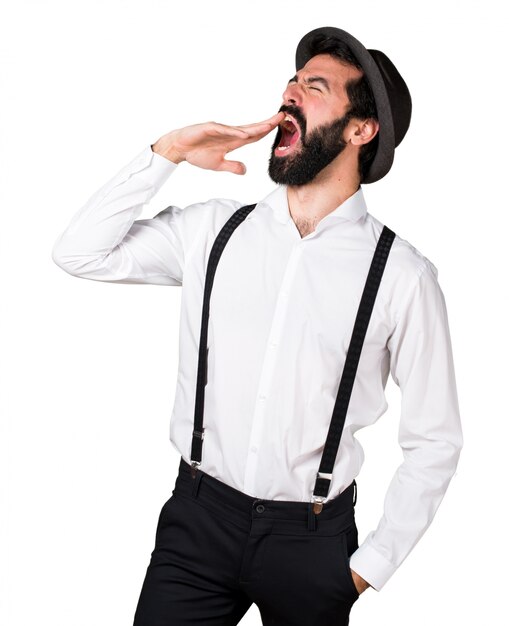 Hipster man with beard yawning