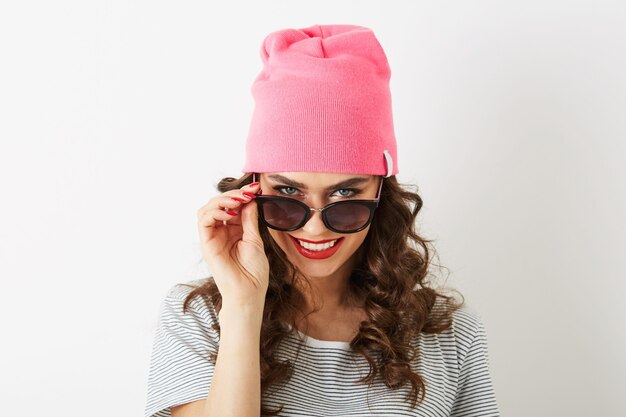 Hipster pretty woman in pink hat, sunglasses, smiling, isolated, white teeth, red lips, curly hair, wearing t-shirt