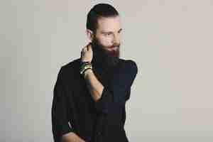 Free photo hipster style bearded man black shirt in studio over white background