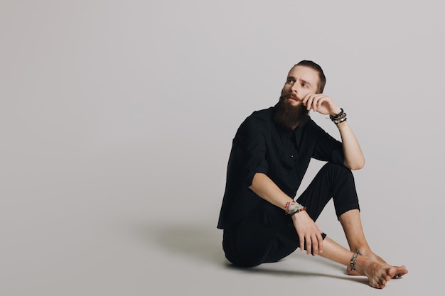 Hipster style bearded man black shirt in studio over white background