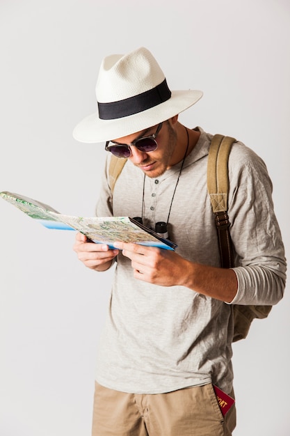 Hipster tourist looking at city map