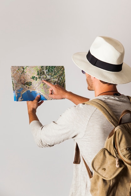 Free photo hipster tourist looking at map