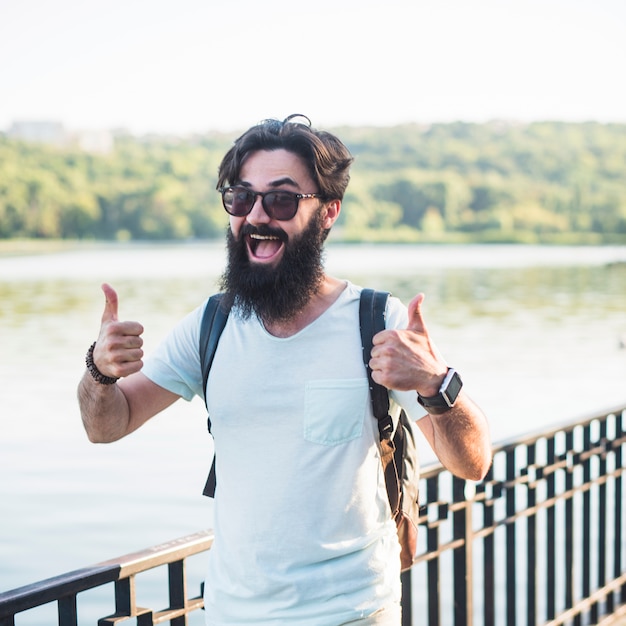 Free photo hipster on vacation next to lake