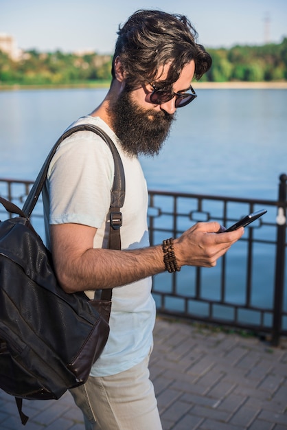 Hipster on vacation next to lake