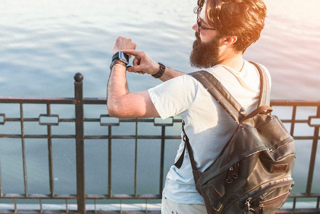 Hipster on vacation next to lake