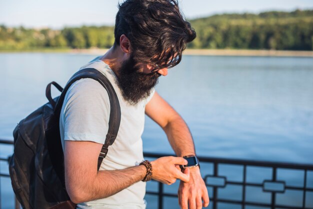 Hipster on vacation next to lake