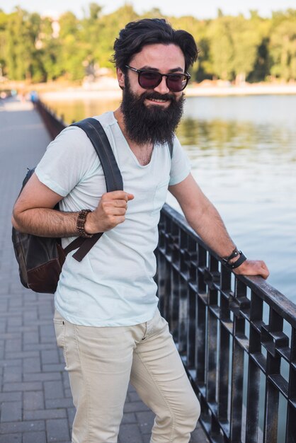 Hipster on vacation next to lake