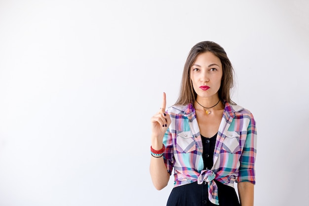 Hipster woman have an idea pointing a finger up