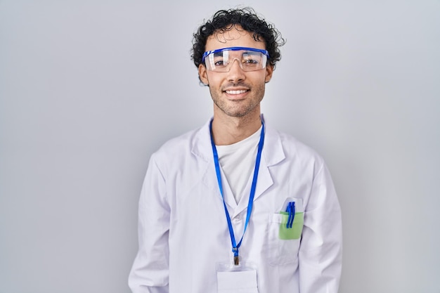 Free photo hispanic man working at scientist laboratory with a happy and cool smile on face lucky person