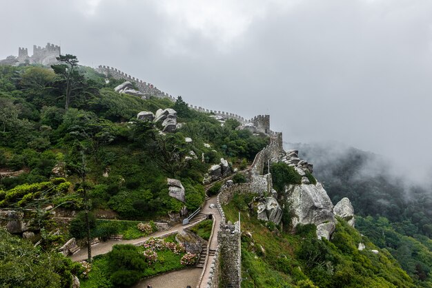 Historic castle of the Moors in Sintra, Portugal on a foggy day