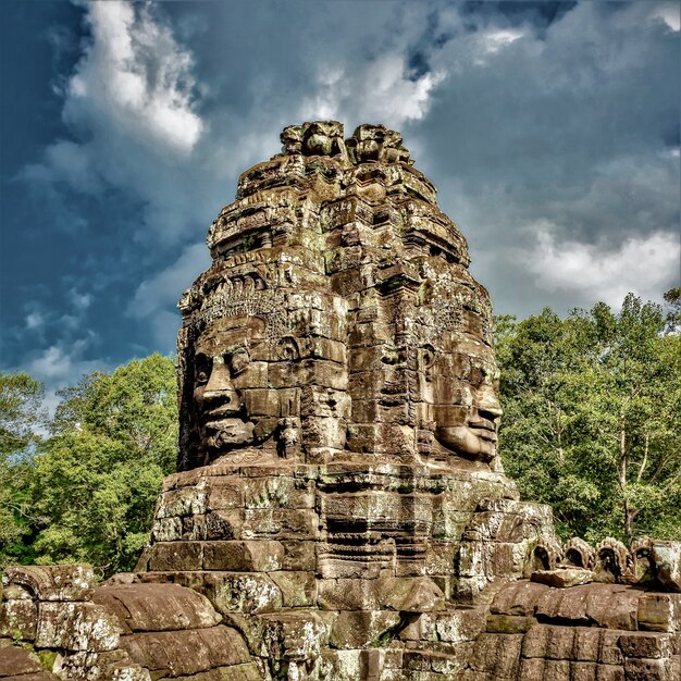 Historic statues at Angkor Thom, Siem Reap, Cambodia under the cloudy sky