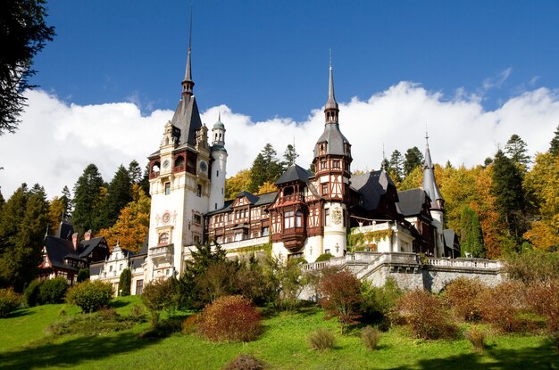 Historical Sinaia Monastery surrounded by green trees in Sinaia, Romania