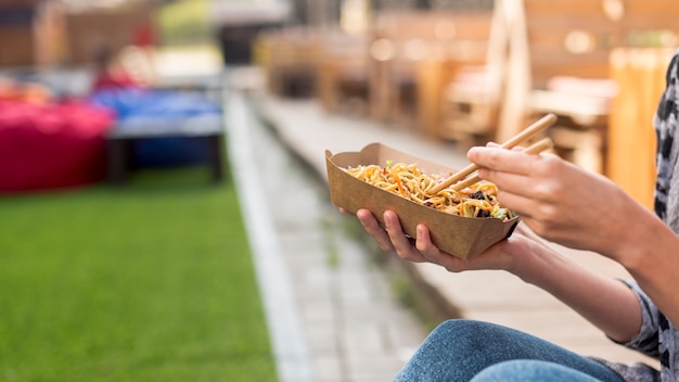 Holding chinese food with blurred background