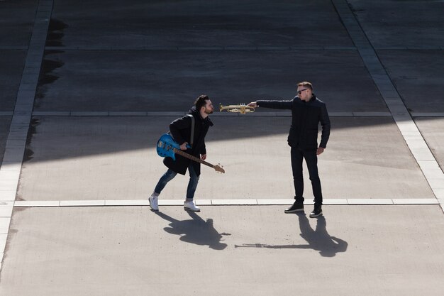 Holding trumpet in friends face