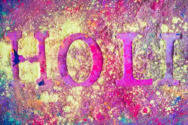 Holi inscription on purple table