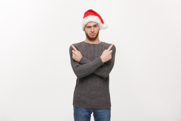 Holiday Concept Young beard man in sweater enjoy playing and pointing finger onside with copyspace