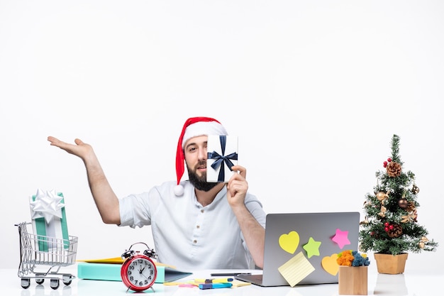 Free photo holiday mood with positive surprised young adult with santa claus hat working