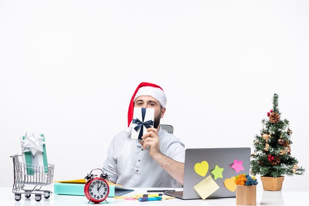 Holiday mood with positive young adult with santa claus hat working