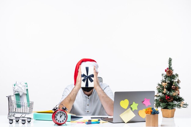 Holiday mood with positive young adult with santa claus hat working