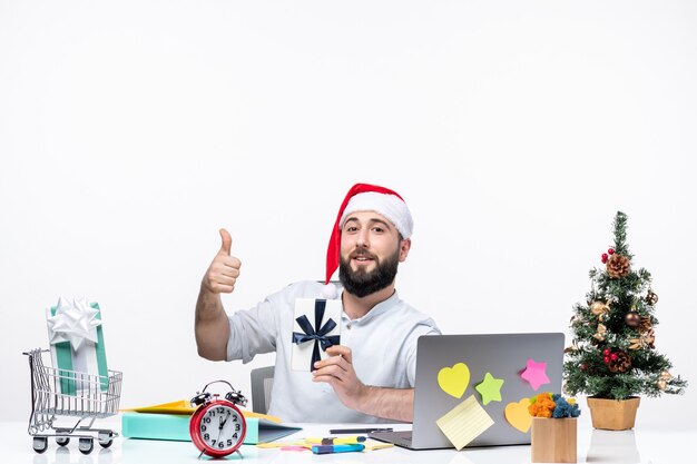 Holiday mood with young adult with santa claus hat working at new year