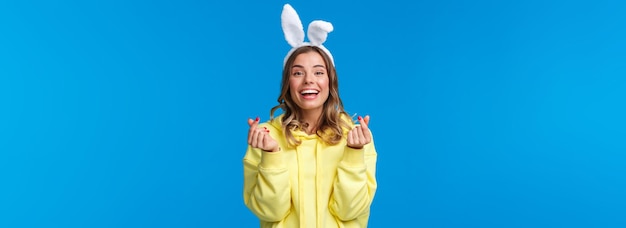 Holidays traditions and celebration concept cheerful european girl celebrating easter day wearing ra