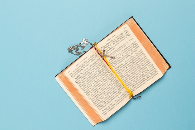 Holy book and necklace with cross