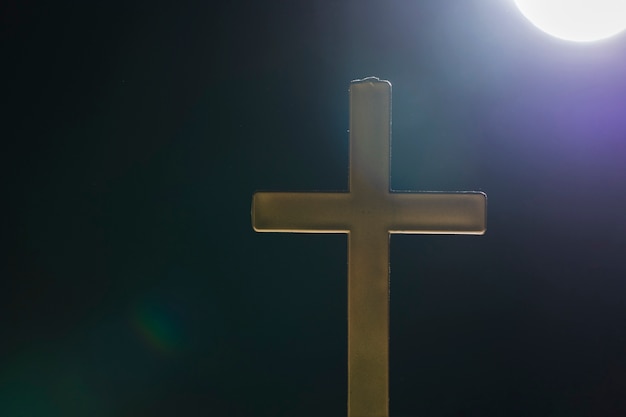 Holy cross outside on full moon