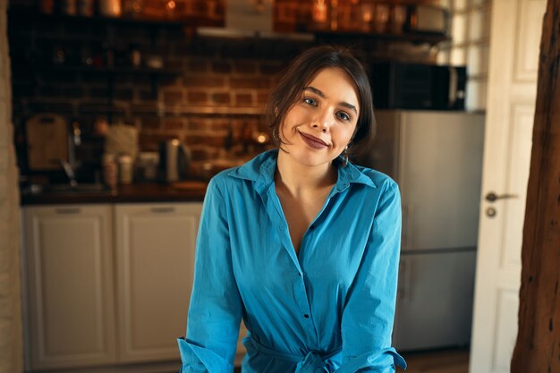 Home, comfort, coziness and domesticity concept. Cropped portrait of confident happy young woman spending day at home