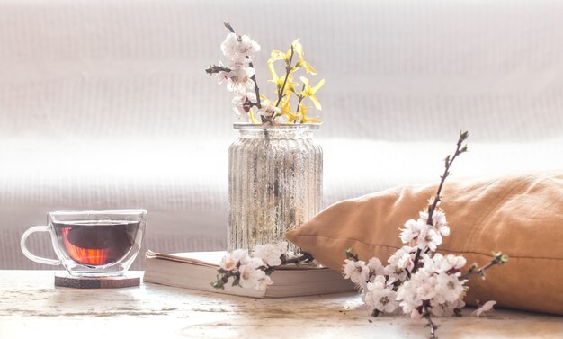 Home decor in living room Cup of tea with spring flowers