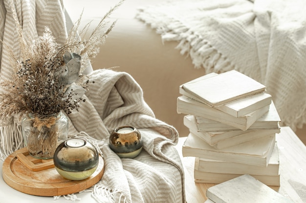 Home interior with books and dried flowers.