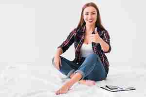 Free photo home lifestyle woman doing thumbs up gesture