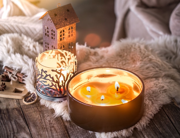 home still life in the interior with beautiful candles, on the background of a cozy home decor