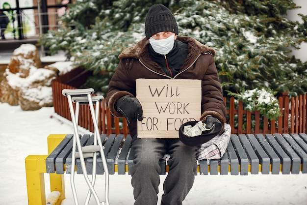 Homeless sitting on a bench.