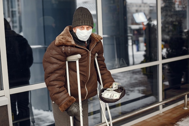 Homeless standing near building.